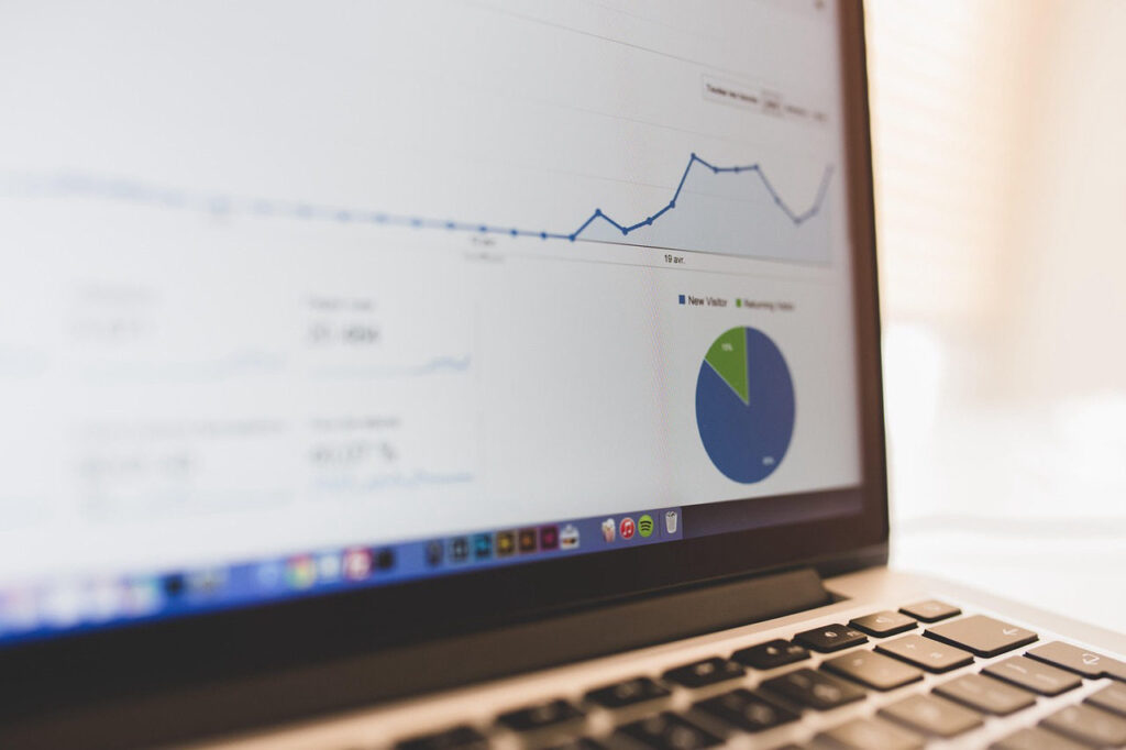 A laptop displaying website analytics charts and graphs, illustrating what is the difference between local SEO and national SEO for service businesses